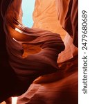 Antelope Canyon in Arizona. Hiking in through the caves. Cool formation pictured, featuring the blue sky contrasting with the bright orange canyon walls.