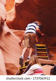 Antelope Canyon, Arizona, USA, 15 April 2019; Motion Blurred Of The Group Of Tourists Climb Up The Metal Ladder To The Exit Of The Cave