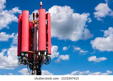 Antenna for mobile phones in front of clouds on sky