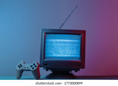 Antenna old-fashioned  tv receiver with gamepad in pink blue gradient neon light. Retro media, entertainment 80s, retro wave - Powered by Shutterstock