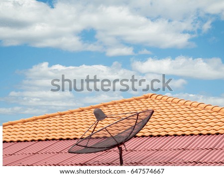 antenna on the roof of the house, the sky clouds