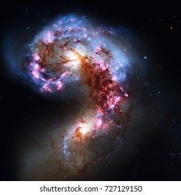 The Antennae Galaxies or NGC 4038 or NGC 4039 are undergoing a galactic collision. Located in the constellation Corvus. Retouched image. Elements of this image furnished by NASA.