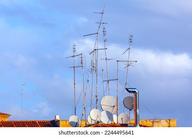 Antennas on an old roof . Rooftop with different antennas - Shutterstock ID 2244495641