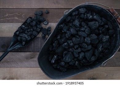 Anthracite nut coal in a coal scuttle with an ash shovel filled with coal - Shutterstock ID 1918937405
