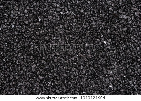 Anthracite surface texture. Black small stones background