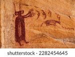 An anthropomorph with bug eyes and antennae appears to send comets or birds out of his hands on the Unexpected Panel, a Barrier Canyon Style ancient rock art site in the desert of central Utah, USA.