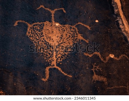 Anthropomorphic figures depicted with antennae or antlers in ancient rock art petroglyphson the 