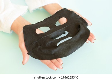 Anti Age Concept. Woman Holds And Applies A Black Cosmetic Mask To Her Face. Mature Woman Spa Treatment. Beauty Spa Treatment. Plastic Surgery Clinic, New Senior, Cosmetology