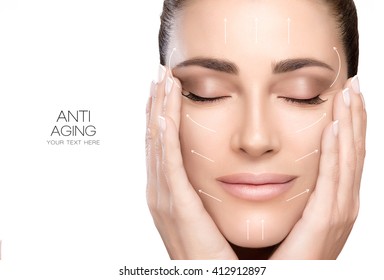 Anti aging treatment and plastic surgery concept. Beautiful young woman with hands on cheeks and eyes closed with a serene expression and white arrows over face. Isolated on white with copy space - Shutterstock ID 412912897
