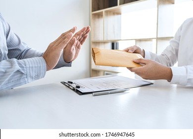 Anti bribery and corruption concept, Business man refusing and don't receive money banknote in envelope offer from business people to accept agreement contract of investment deal.