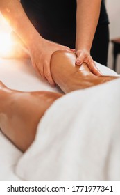 Anti Cellulite Massage. Masseuse Massaging A Calf Area Of A Female Leg To Reduce Cellulite 