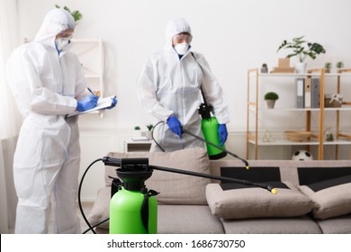 Anti coronavirus disinfection. Men in hazmat suits cleaning home, epidemic, quarantine