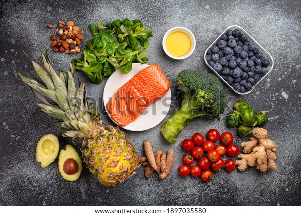 Anti inflammatory diet concept. Set of foods\
that help to reduce inflammation - plant based ingredients, fresh\
fruit, green vegetables. Healthy diet products, top view, stone\
background