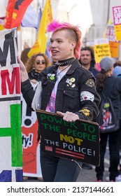 Anti Racism Protest On The Streets Of London. A Protestor With Pink Punk Style Haircut Holding A Banner. London - 19th March 2022