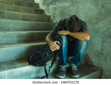 Anti Sexual Discrimination And Against Homophobia Campaign. Young Sad And Depressed College Student Man Sitting On Staircase Desperate Victim Of Harassment Suffering Bullying And Abuse 