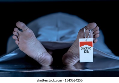 Anti smoking advertising design image. Dead body at morgue with toe tag with text Smoking kills written on it. Social awareness campaign Say NO to Tobacco and health effects of cigarette smoking. - Shutterstock ID 1543624256