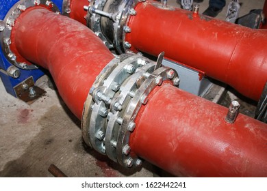 Anti vibration rubber expansion joints large and small in the pipeline in industrial production line. Red and blue pipes. Selective focus.