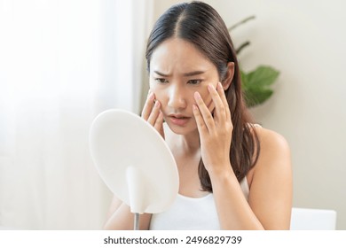 Anti wrinkle aging, worry puberty asian young woman, stressed looking in mirror, allergy presenting allergic reaction from cosmetic on face. Beauty, health care from acne problem, dry skin, treatment. - Powered by Shutterstock