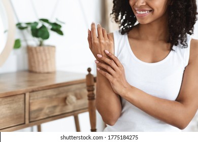 Anti-Aging Hand Care. Smiling African Woman Touching Her Soft Body Skin After Beauty Tratment At Home, Cropped Image, Free Space