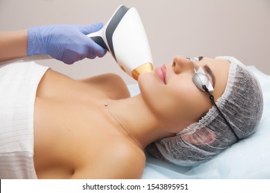 Anti-aging Procedures. Skin Care Concept. Woman Receiving Facial Beauty Treatment, Removing Pigmentation At Cosmetic Clinic. Intense Pulsed Light Therapy. IPL. Rejuvenation, Photo Facial Therapy. 
