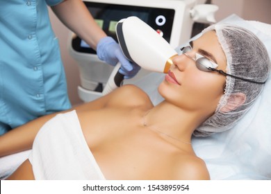 Anti-aging Procedures. Skin Care Concept. Woman Receiving Facial Beauty Treatment, Removing Pigmentation At Cosmetic Clinic. Intense Pulsed Light Therapy. IPL. Rejuvenation, Photo Facial Therapy. 
