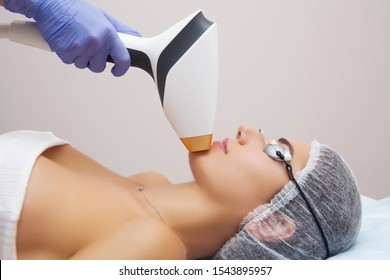 Anti-aging Procedures. Skin Care Concept. Woman Receiving Facial Beauty Treatment, Removing Pigmentation At Cosmetic Clinic. Intense Pulsed Light Therapy. IPL. Rejuvenation, Photo Facial Therapy. 
