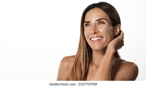 Anti-aging skin lifting beauty. Smiling adult woman in her mid 40s, has hyaluronic acid skin care treatment, smooth nourished face, standing over white background