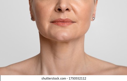 Anti-Aging Skincare. Cropped Portrait Of Middle-aged Woman With Beautiful Skin, Light Background, Closeup