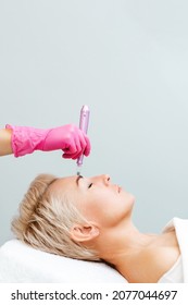 Anti-aging treatment and face lift. Adult woman at a mesotherapy session in a professional clinic of aesthetic medicine. Vertical. Copy space.