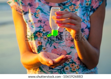 antibacterial agent in the hand. the concept of cleanliness and health. mother inflicts antiseptic on a child's hand