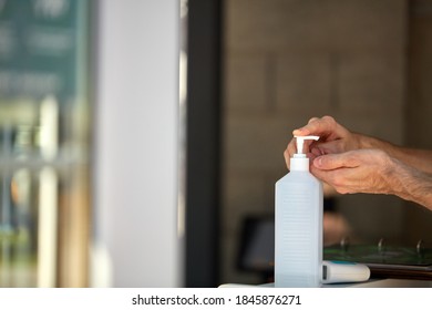 Antibacterial Hand Sanitizer Bottle At Building Entrance For People Washing Hands To Stop Spreading Outbreak Coronavirus Covid-19 For Public Health Safety, Man Apply It On Hand. Close-up