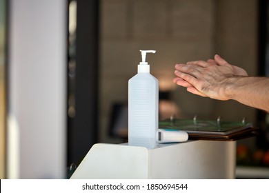 Antibacterial Hand Sanitizer Bottle At Building Entrance For People Washing Hands To Stop Spreading Outbreak Coronavirus Covid-19 For Public Health Safety, Man Apply It On Hand. Close-up