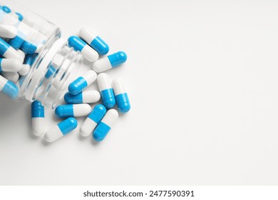 Antibiotic pills and bottle on white background, top view. Space for text - Powered by Shutterstock