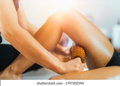 Anti-cellulite Madero Therapy Thigh Treatment With Rolling Pin. Female Masseuse Performing Cellulite Reduction Treatment