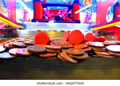 Anticipation: Two Pence Coins Teeter On The Edge Inside A Coin Pusher Machine