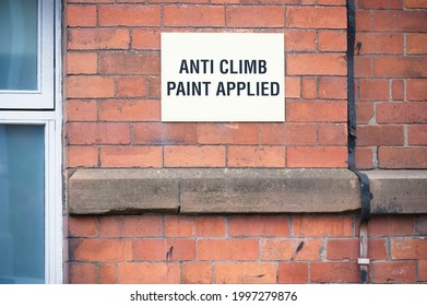 Anti-climb paint sign on wall of private property 