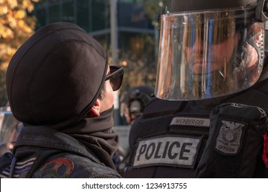 An Antifa Protester Confronts Police Officer Clad In Riot Gear During A Stand With Survivors Rally In Portland Oregon.  Took Place On November 17,2018.