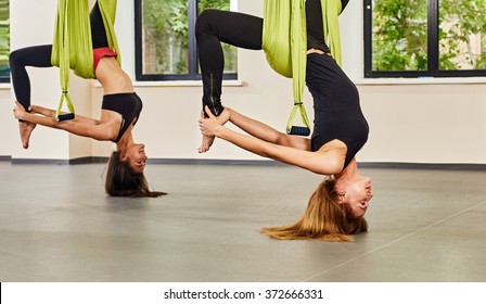 Antigravity Yoga Exercise. Twwo Girls