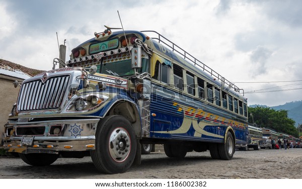 ANTIGUA / GUATEMALA - AUGUST 4, 2018: Public\
transport in Guatemale is done with old american school buses\
painted in fresh\
colors.