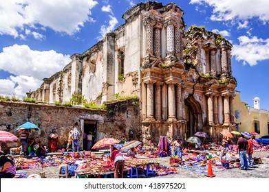 Antigua, Guatemala - October 4, 2014: Weekend Mayan textile market in cobblestone street outside El Carmen ruins in colonial city & UNESCO World Heritage Site of Antigua.