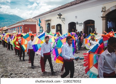 Antigua Guatemala - September 15th 2018: Children carry colorful decorations in street parade during Dia de la Independencia (Independence Day) in Guatemala