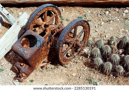 Antigue rusted Iron Wagon hitch with wheels on iron axle