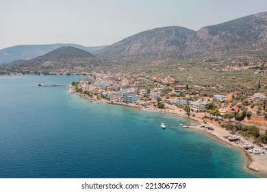 Antikyra Village Greece, Aerial Drone View. Waterfront Buildings, Boats, Calm Sea, Sunny Day In Boeotia