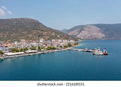 Antikyra Village Greece, Aerial Drone View. Waterfront Buildings, Anchored Boats, Calm Sea, Sunny Day In Boeotia