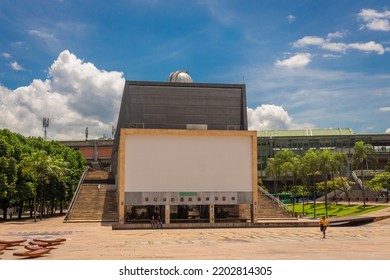 Medellín, Antioquia, Colombia June 1, 2018 The Park Of Desires Is An Urban Park Where People Have Fun And Children Play On A Sunny Day, The Planetarium Of Medellin And The Metro Station Of The Univers