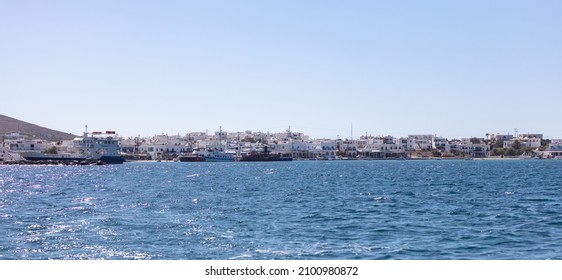 Antiparos island Cyclades Greece. Panoramic view of harbor boats in Aegean sparkle sea whitewashed seaside buildings shops cafe taverns blue sky. Summer destination - Shutterstock ID 2100980872