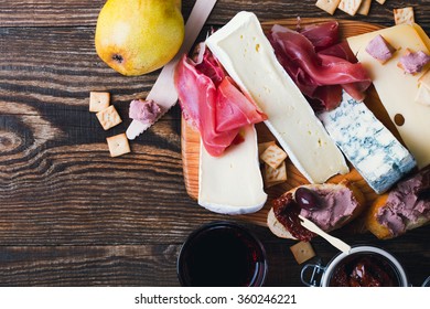 Antipasti Platter With Different Meat And Cheese Products On  Wooden Board. Top View