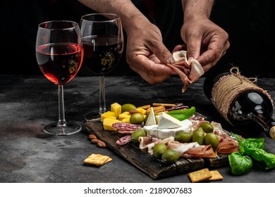 Antipasto board Platter with Spanish ham jamon serrano or Italian prosciutto crudo, Italian hard cheese pecorino toscano on a dark background. aperitivo party. - Shutterstock ID 2189007683