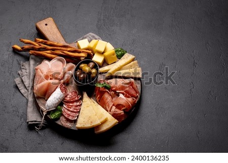 Antipasto board with various meat and cheese snacks. Wth copy space