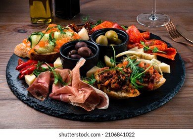 Antipasto Tray With Prosciutto, Salami, Cheese, Olives, Artichokes And Bruschetta. Antipasto Board